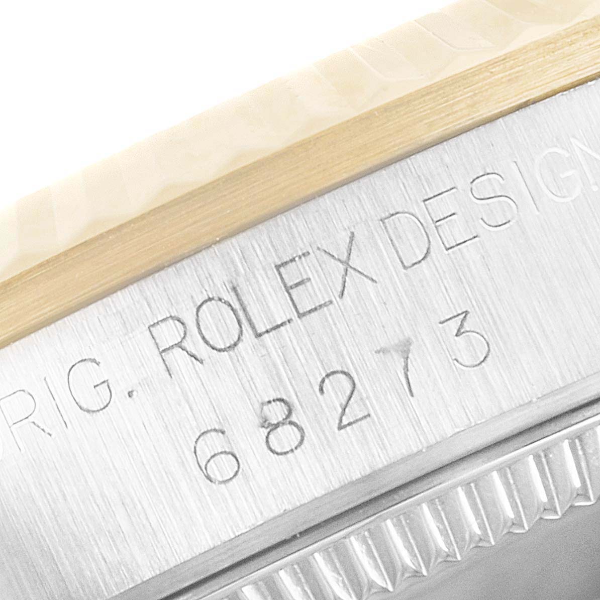 This close-up image shows the model number 68273 engraved on the case of a Rolex Mid-Size 68273 Women
s Steel and Gold (two tone) Silver Dial 68273 Women
s Steel and Gold (two tone) Silver Dial watch.