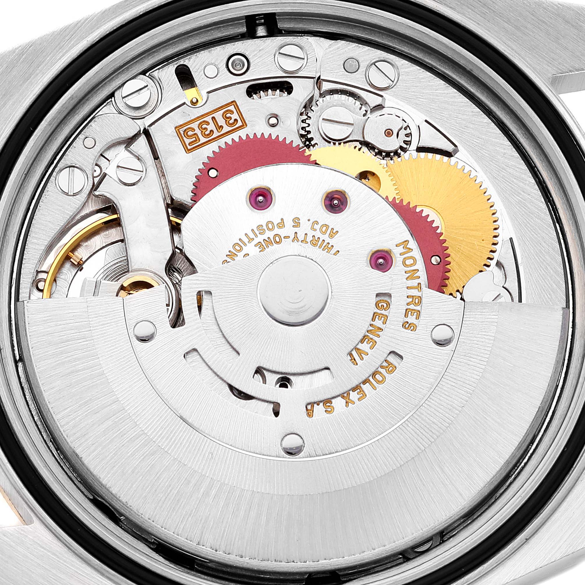 The image shows the internal mechanism of a Rolex Datejust 16233 Men's Steel and Gold (two tone) Silver Dial 16233 Men's Steel and Gold (two tone) Silver Dial watch from a close-up, showcasing its intricate gears and components.