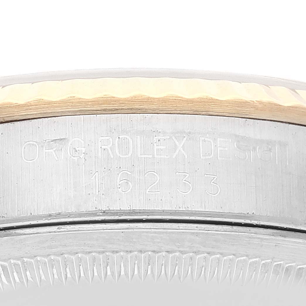 The image shows a close-up of the side of a Rolex Datejust 16233 Men's Steel and Gold (two tone) White Dial 16233 Men's Steel and Gold (two tone) White Dial model 16233, displaying engravings on the case.