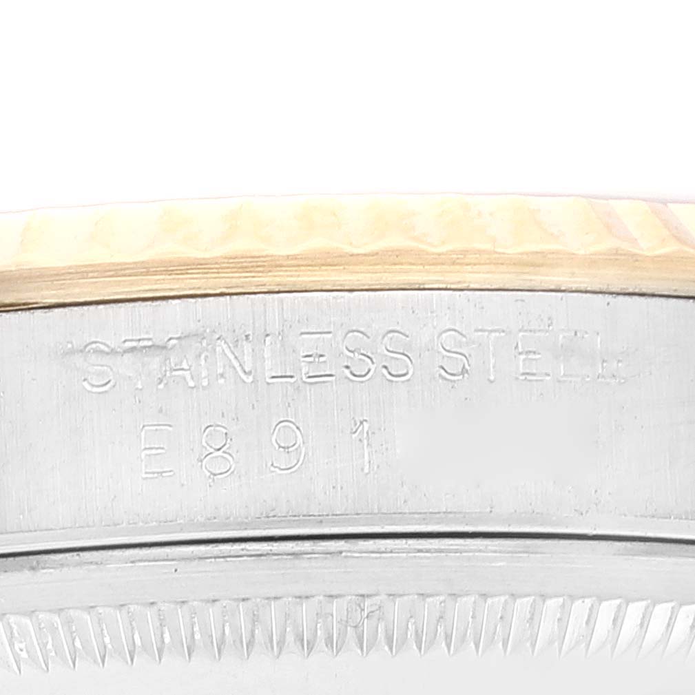 The image shows a close-up angle of the side of a Rolex Datejust 16233 Men's Steel and Gold (two tone) White Dial 16233 Men's Steel and Gold (two tone) White Dial watch, highlighting the stainless steel engraving and part of the bezel.