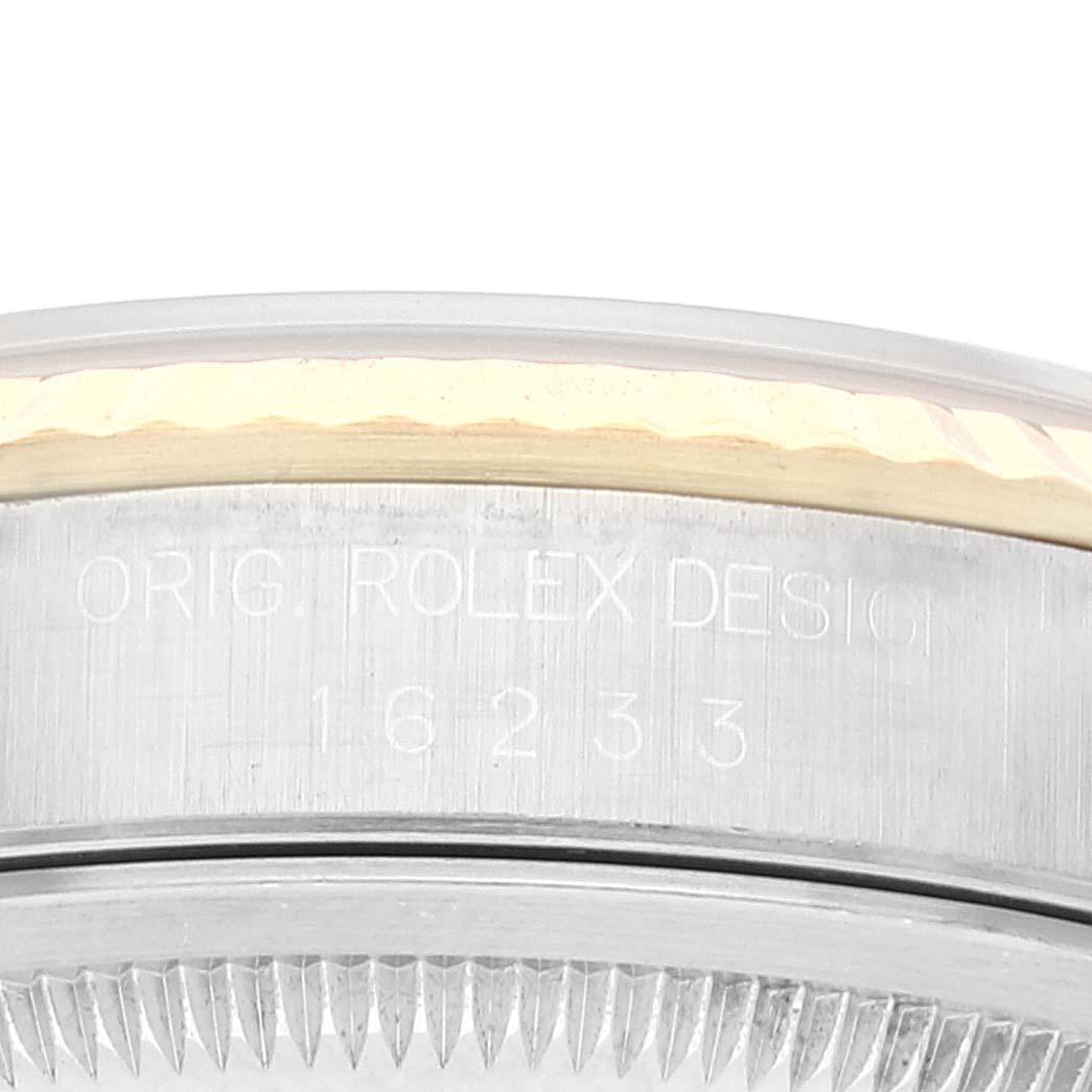 This image shows a close-up of the engraved side of the case bezel on a Rolex Datejust 16233 Men's Steel and Gold (two tone) White Dial 16233 Men's Steel and Gold (two tone) White Dial watch.