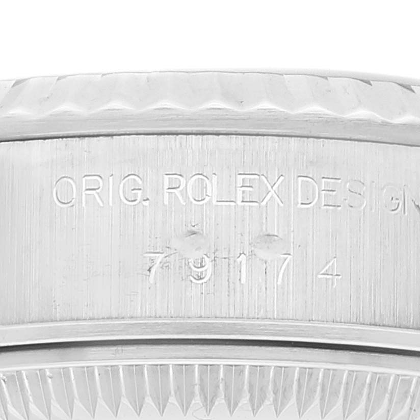 Close-up of the side of a Rolex Datejust 79174 Women's Stainless Steel Blue Dial 79174 Women's Stainless Steel Blue Dial watch case, showing the engraved serial and model numbers.