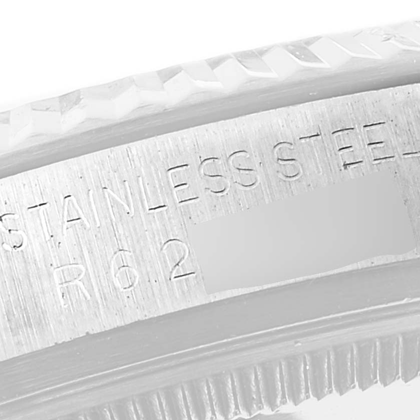 This close-up image shows the engraved part of a Rolex Vintage Collection 16014 Men
s Stainless Steel Silver Dial 16014 Men
s Stainless Steel Silver Dial watch, specifically its stainless steel bezel.