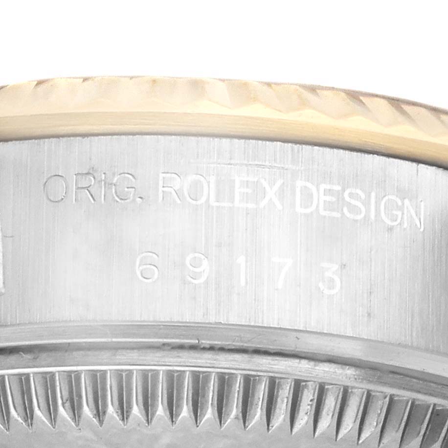 This image shows a close-up side view of the case back and edge of a Rolex Datejust 69173 Women's Steel and Gold (two tone) Champagne Dial 69173 Women's Steel and Gold (two tone) Champagne Dial watch with "ORIG. ROLEX DESIGN" and serial number engraving.