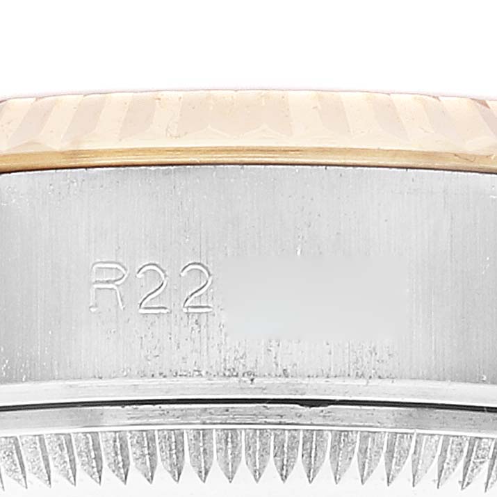 This image shows a close-up of the engraved serial number and the fluted bezel of a Rolex Datejust 69173 Women's Steel and Gold (two tone) Champagne Dial 69173 Women's Steel and Gold (two tone) Champagne Dial watch.