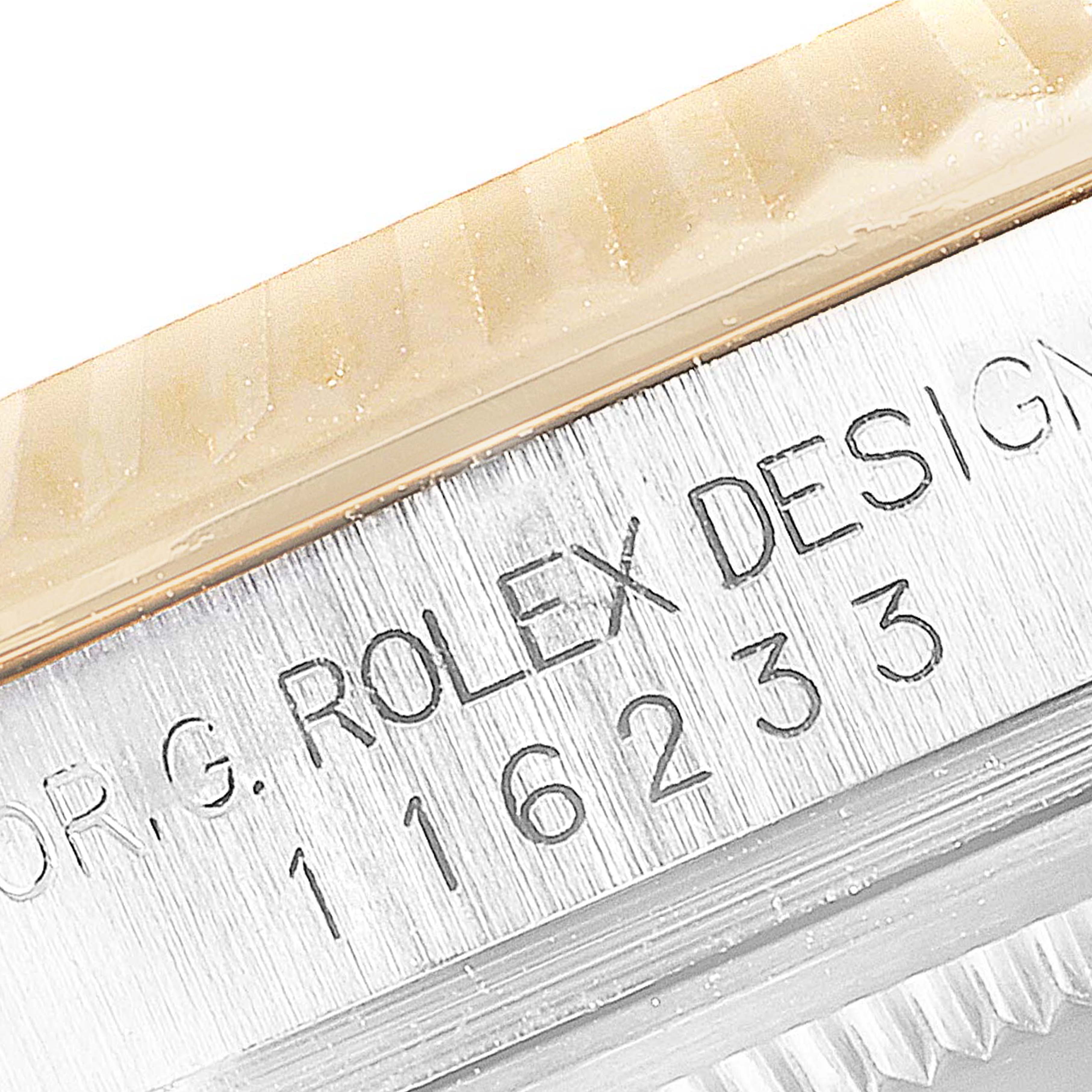 This close-up image shows the edge of the bezel and the model number engraved on the side of a Rolex Datejust 116233 Men's Steel and Gold (two tone) Black Dial 116233 Men's Steel and Gold (two tone) Black Dial watch.
