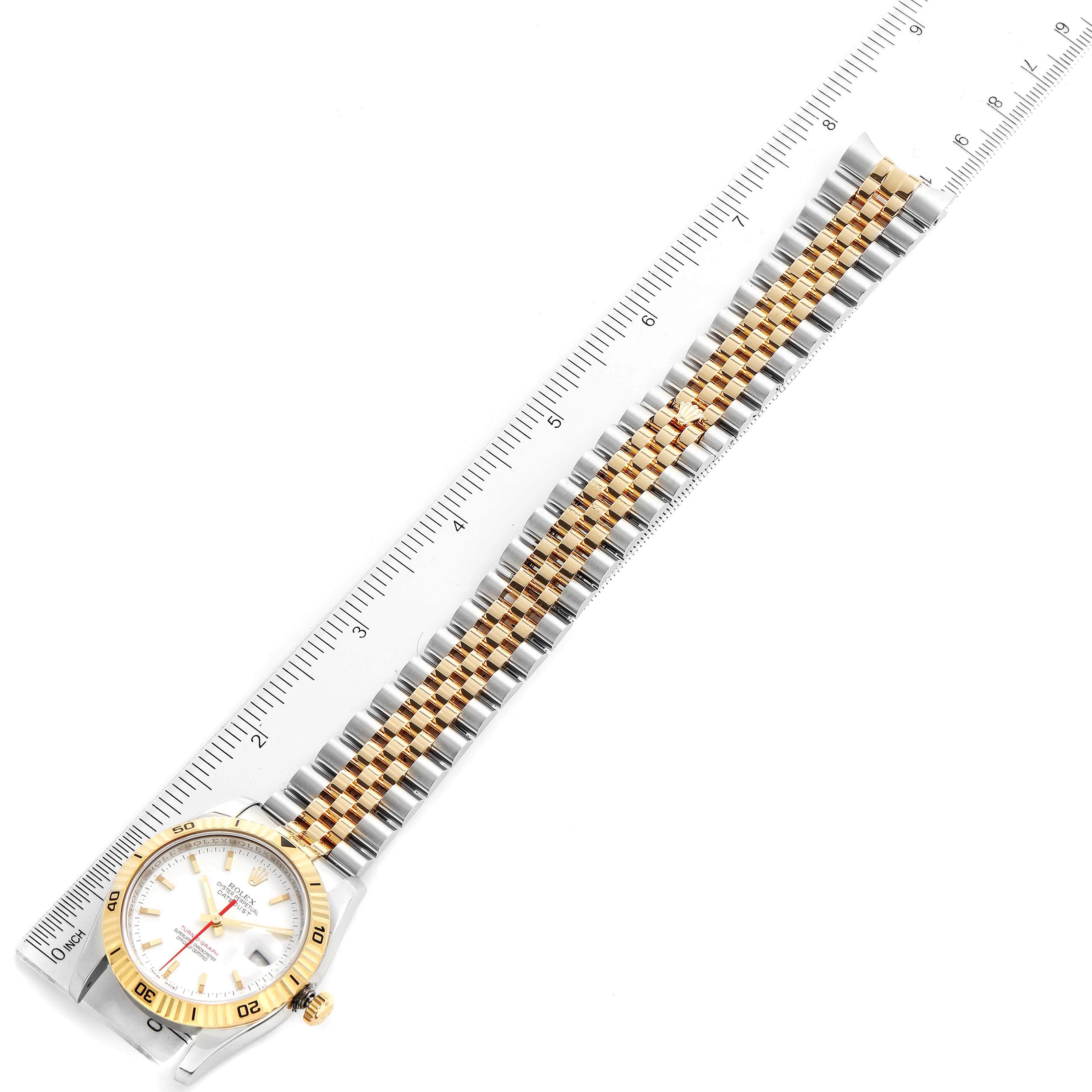 The Rolex Turn-o-Graph 116263 Men
s Steel and Gold (two tone) White Dial 116263 Men
s Steel and Gold (two tone) White Dial watch is shown flat with the face, bezel, and full band visible alongside a measuring ruler.