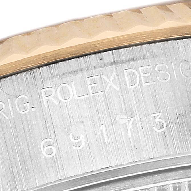 This close-up image shows the engraved case back and bezel of a Rolex Datejust 69173 Women's Steel and Gold (two tone) White Dial 69173 Women's Steel and Gold (two tone) White Dial watch.