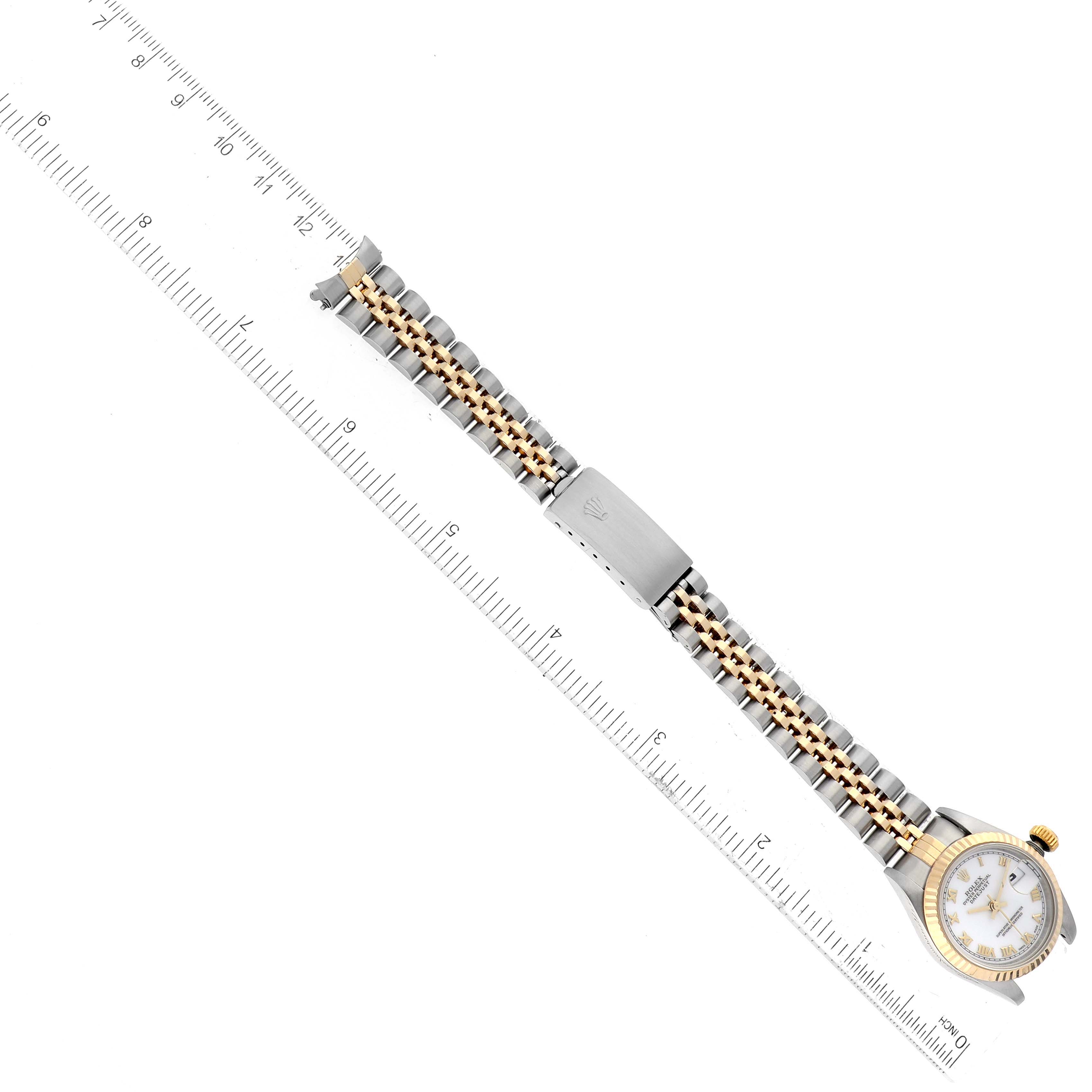 The image shows a Rolex Datejust 69173 Women's Steel and Gold (two tone) White Dial 69173 Women's Steel and Gold (two tone) White Dial watch placed horizontally with its full bracelet extended and aligned next to a ruler.