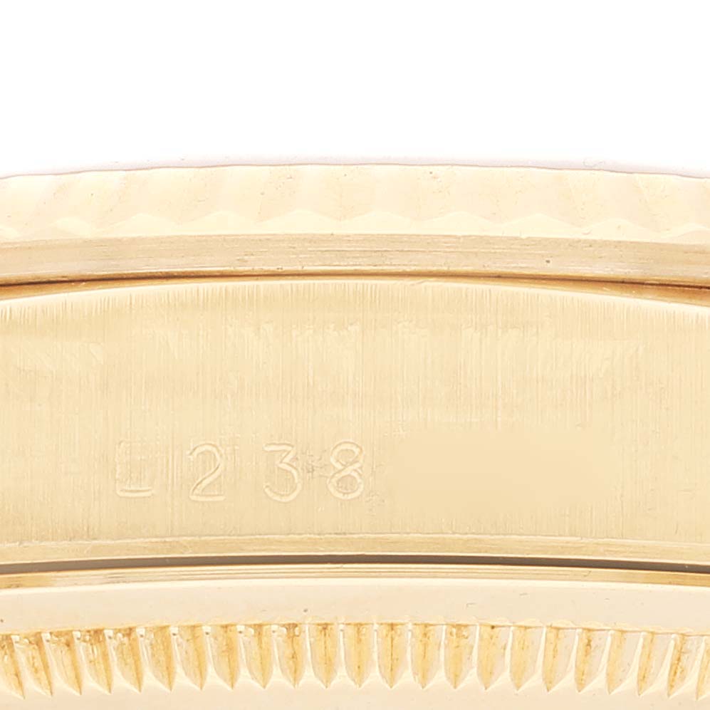This is a close-up of the fluted bezel and engraved serial number on the Rolex President 18238 Men
s Yellow Gold Champagne Dial 18238 Men
s Yellow Gold Champagne Dial watch.