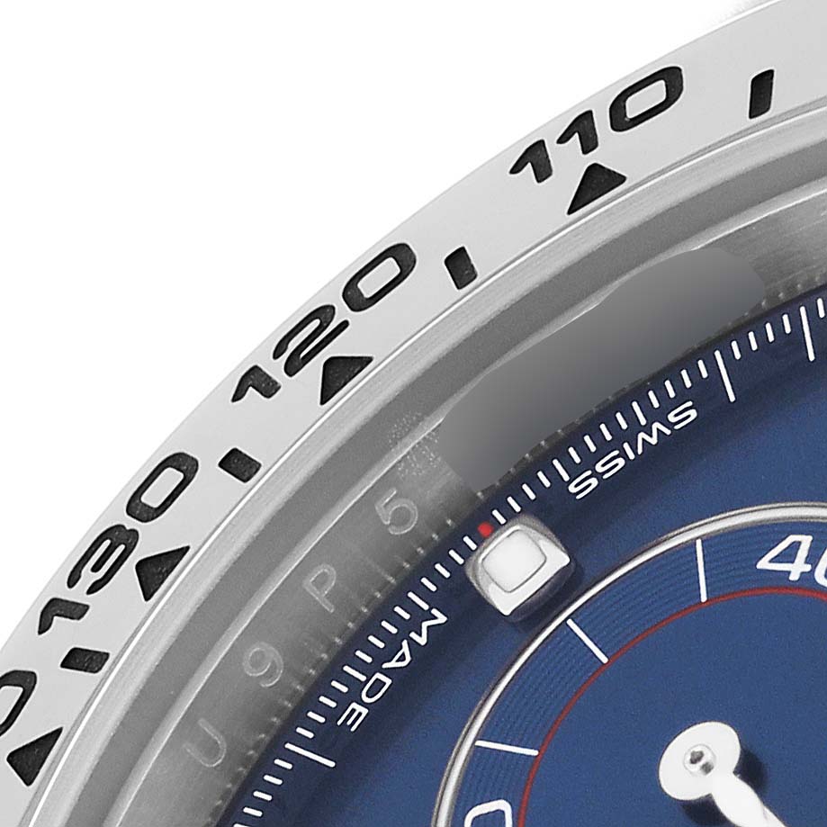 This is a close-up of the bezel and part of the dial of a Rolex Daytona 116509 Men's White Gold Blue Dial 116509 Men's White Gold Blue Dial watch.