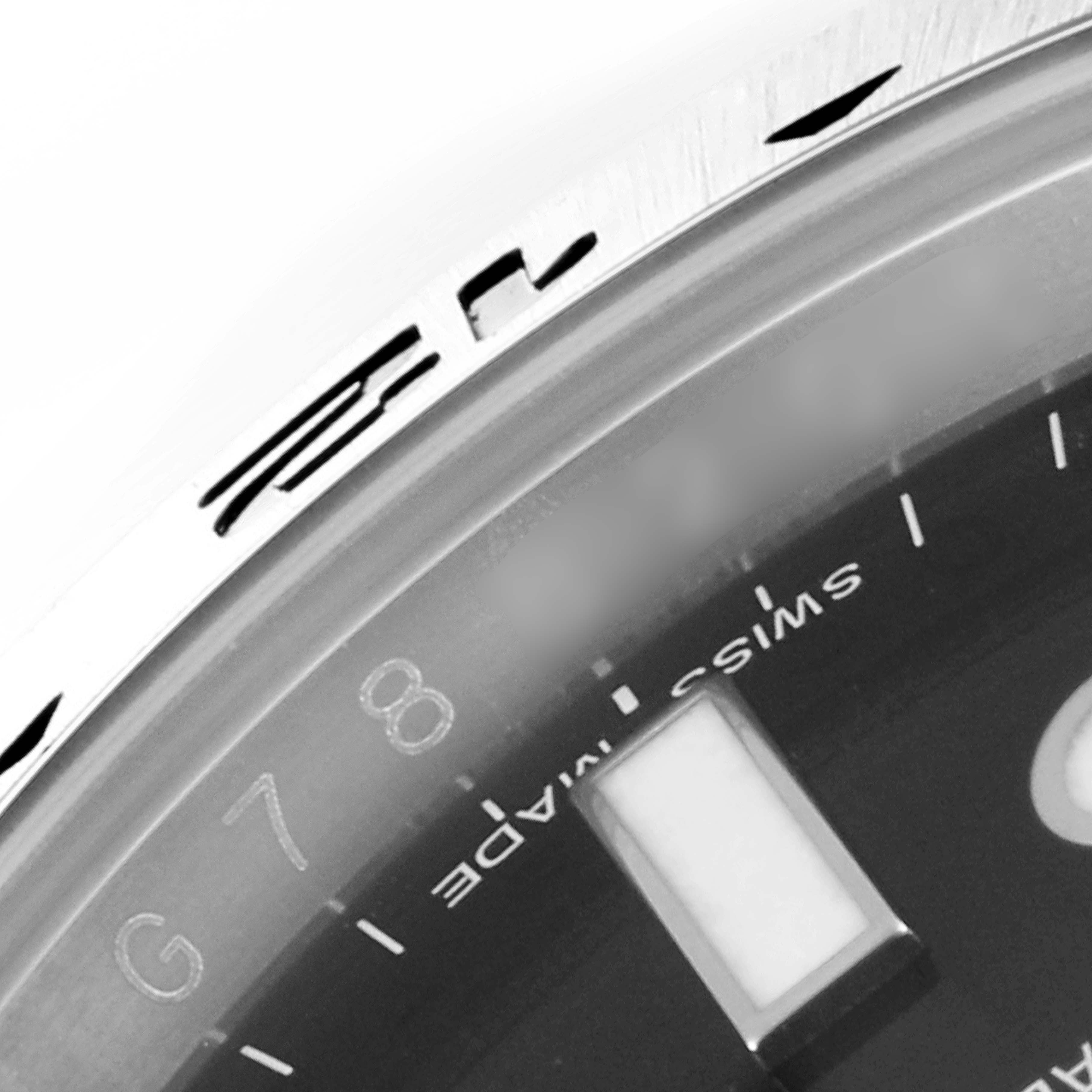 The image shows a close-up of the bezel and part of the dial of a Rolex Explorer 216570 Men's Stainless Steel Black Dial 216570 Men's Stainless Steel Black Dial watch, highlighting the "Swiss Made" text.