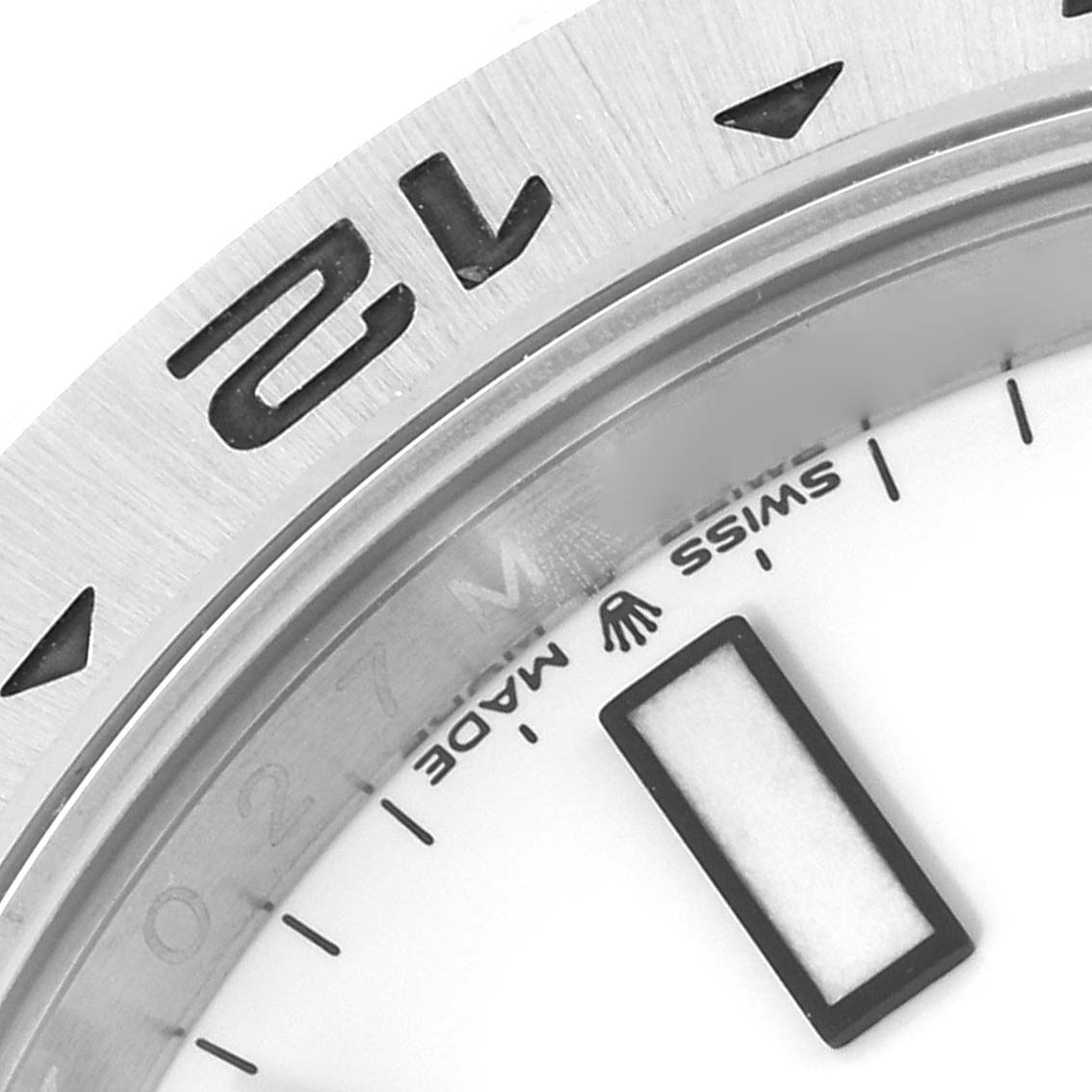 The image shows a close-up of the bezel and partial dial of a Rolex Explorer model 226570, highlighting the 24-hour markings and the "Swiss Made" text.