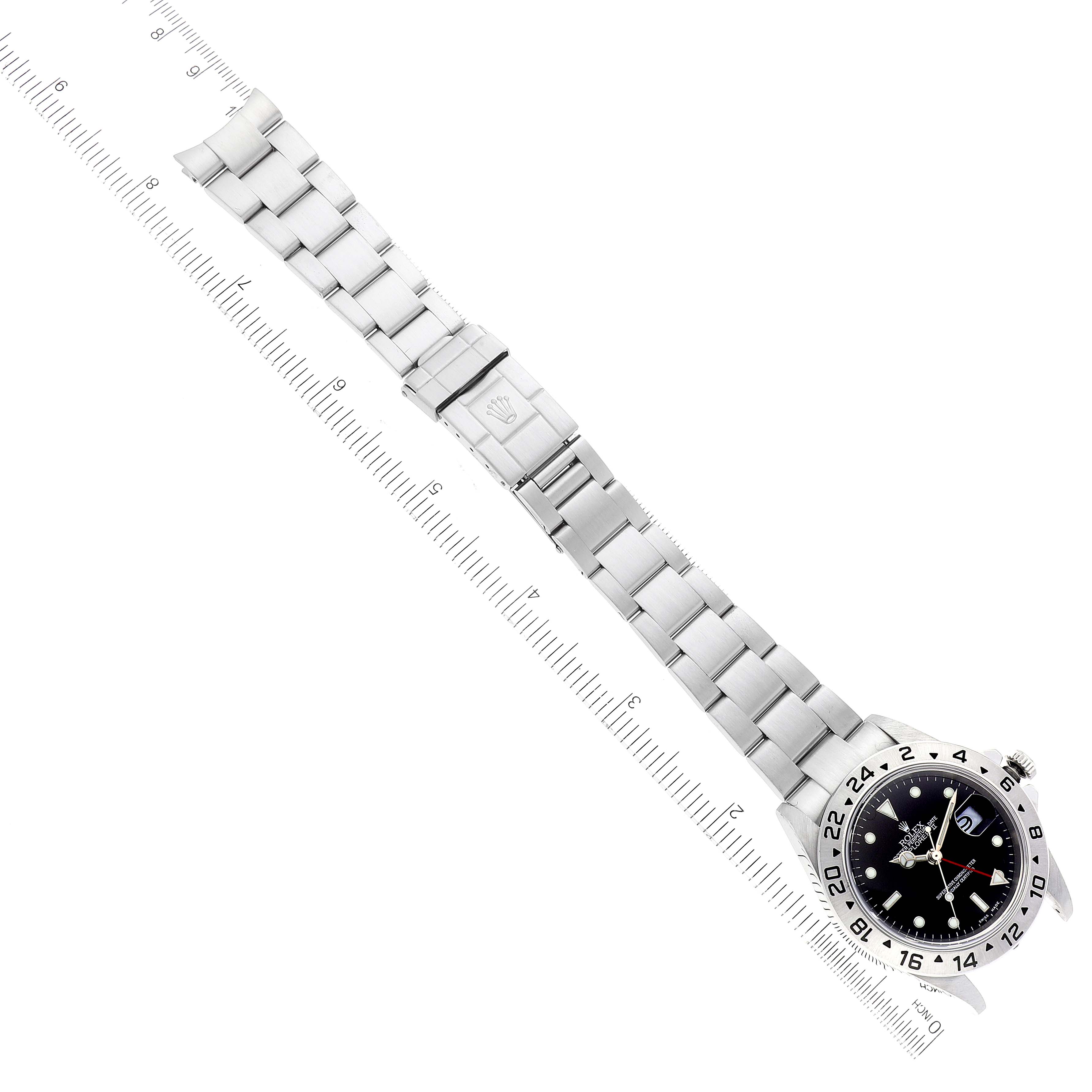 The image shows the full Rolex Explorer 16570 Men's Stainless Steel Black Dial 16570 Men's Stainless Steel Black Dial model laid flat with a stainless steel bracelet and a ruler for scale.