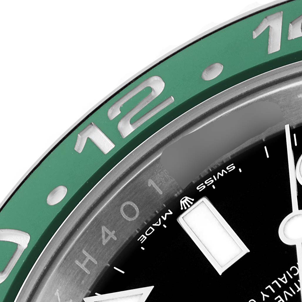 This close-up image of a Rolex GMT-Master 126720VTNR Men's Stainless Steel Black Dial 126720VTNR Men's Stainless Steel Black Dial watch shows part of the green bezel and black dial at an oblique angle.