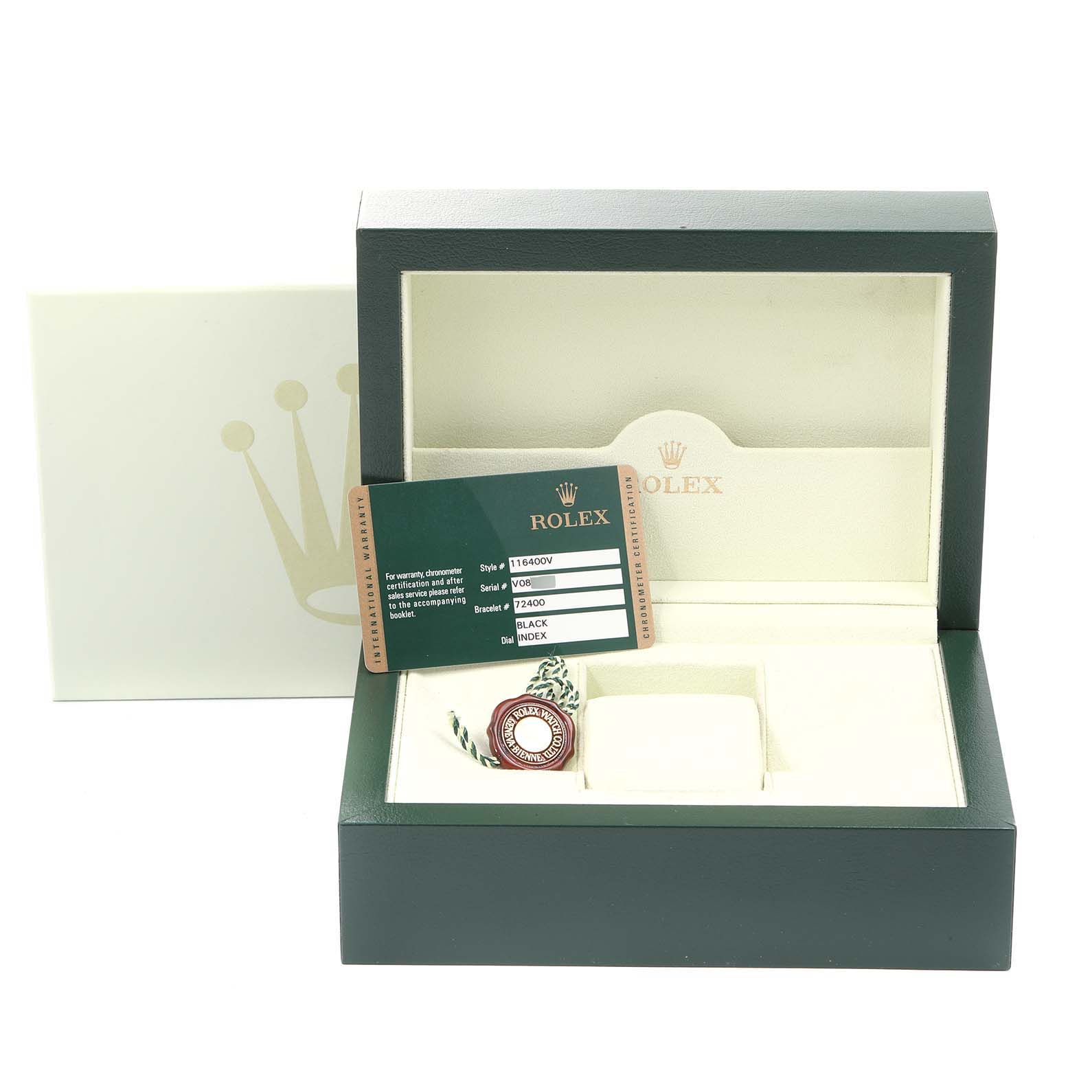 The image shows a Rolex Milgauss 116400GV Men
s Stainless Steel Black Dial 116400GV Men
s Stainless Steel Black Dial watch box with its certification card and tag, with the box open and empty.