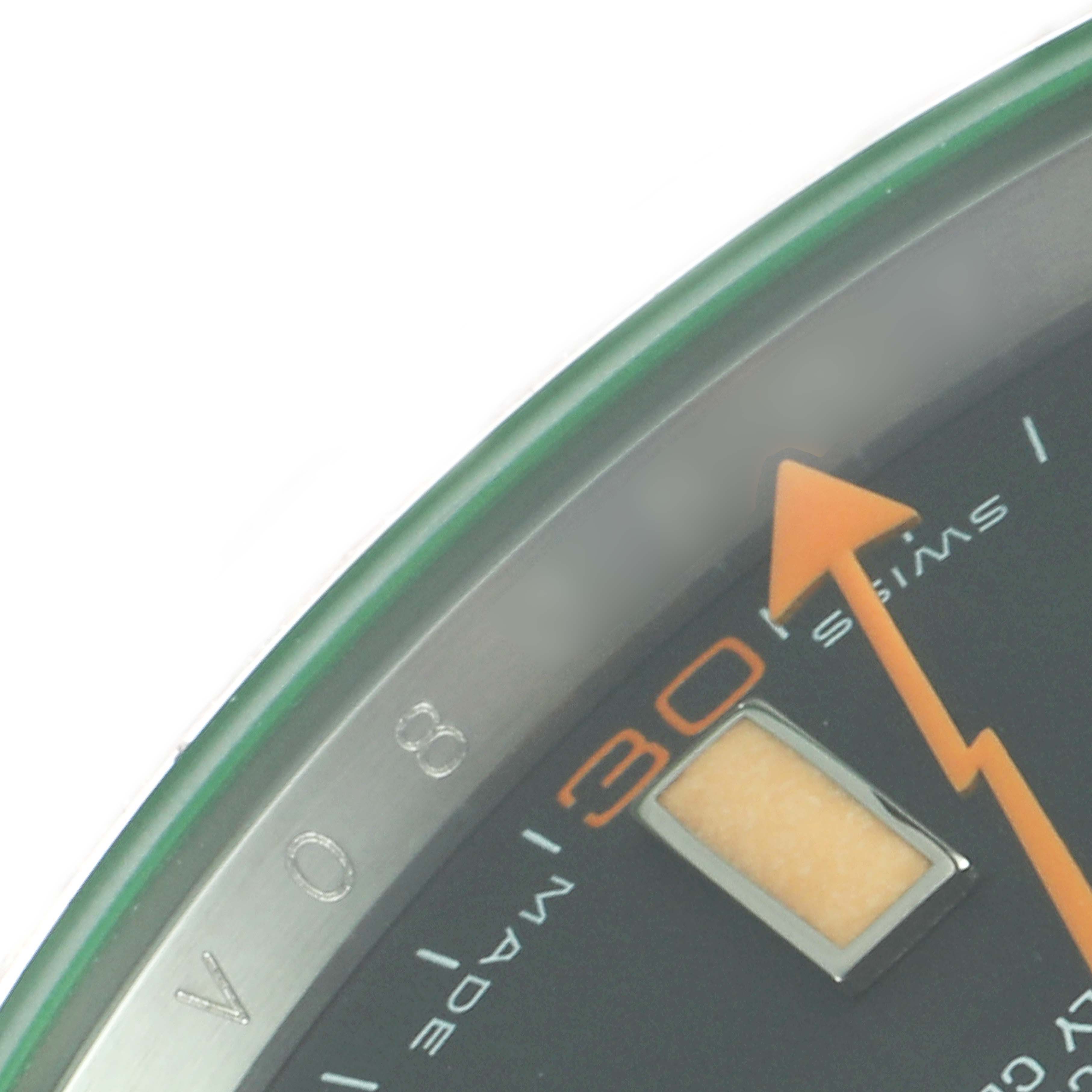 The image shows a close-up of the dial of a Rolex Milgauss 116400GV Men
s Stainless Steel Black Dial 116400GV Men
s Stainless Steel Black Dial watch, highlighting part of the minute markers and the orange lightning bolt second hand.