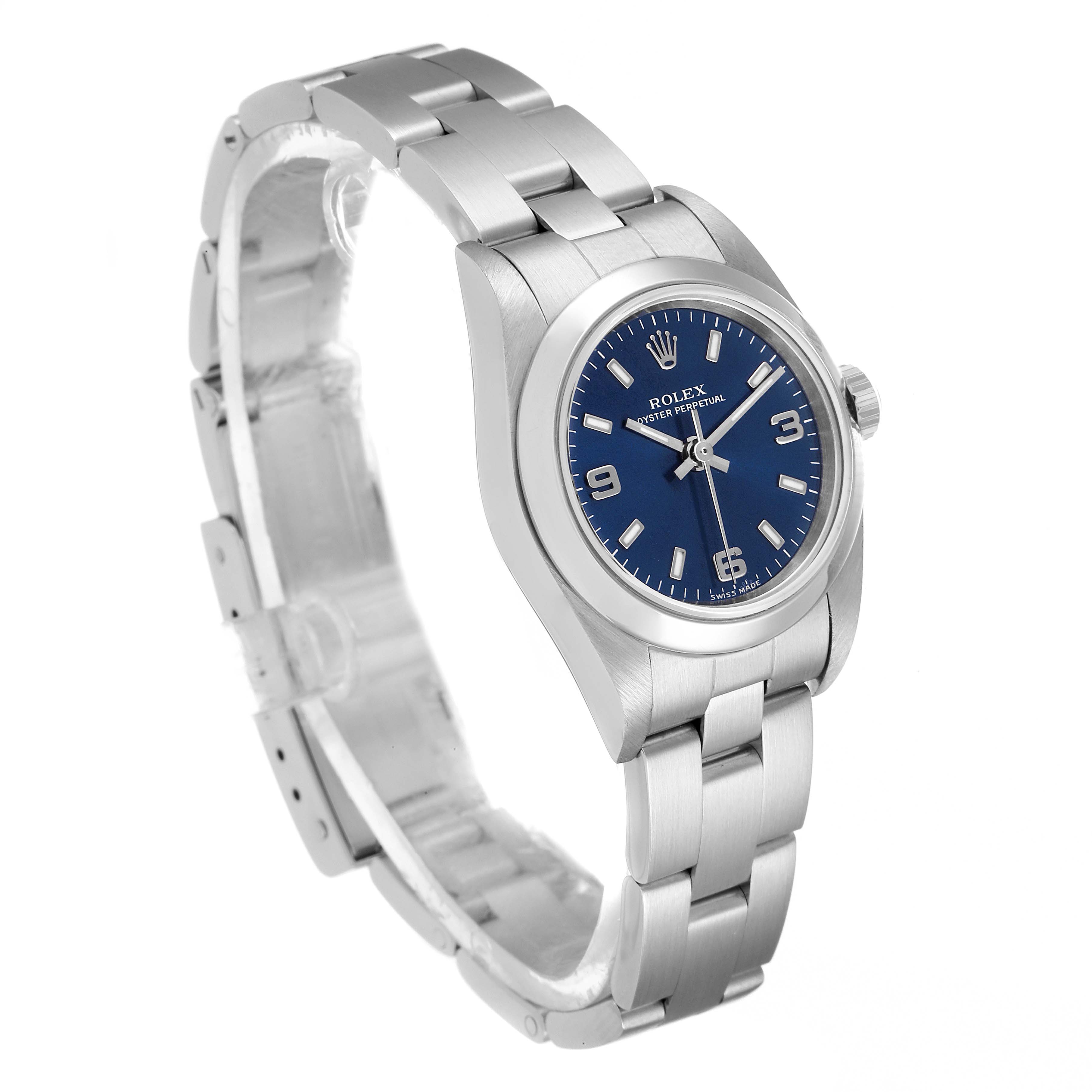 The Rolex Oyster Perpetual 76080 Women
s Stainless Steel Blue Dial 76080 Women
s Stainless Steel Blue Dial watch is shown at an angle displaying its face, crown, and part of the metal bracelet.