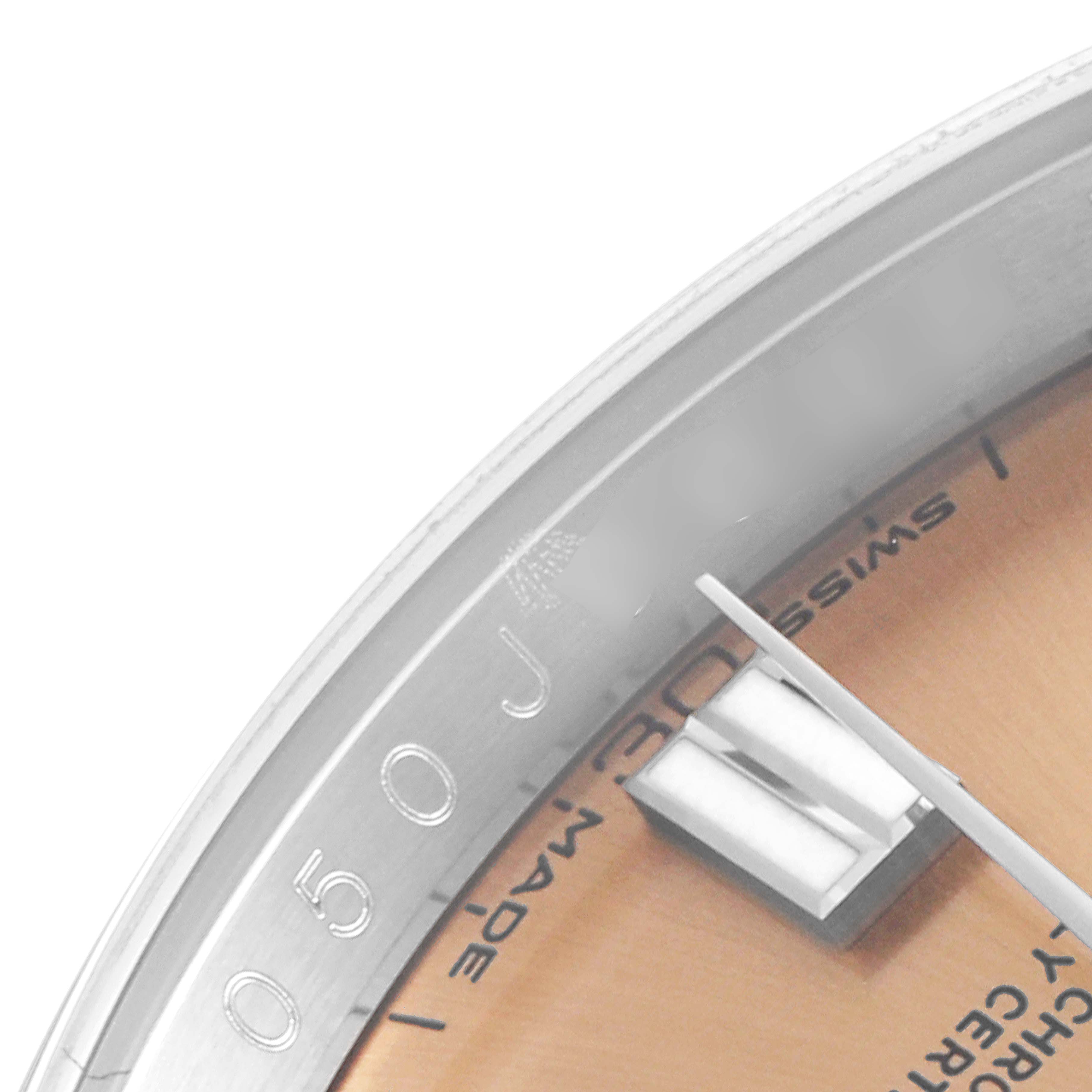 This image shows a close-up angle of the dial and upper bezel of a Rolex Oyster Perpetual 116000 Men's Stainless Steel Champagne Dial 116000 Men's Stainless Steel Champagne Dial watch.