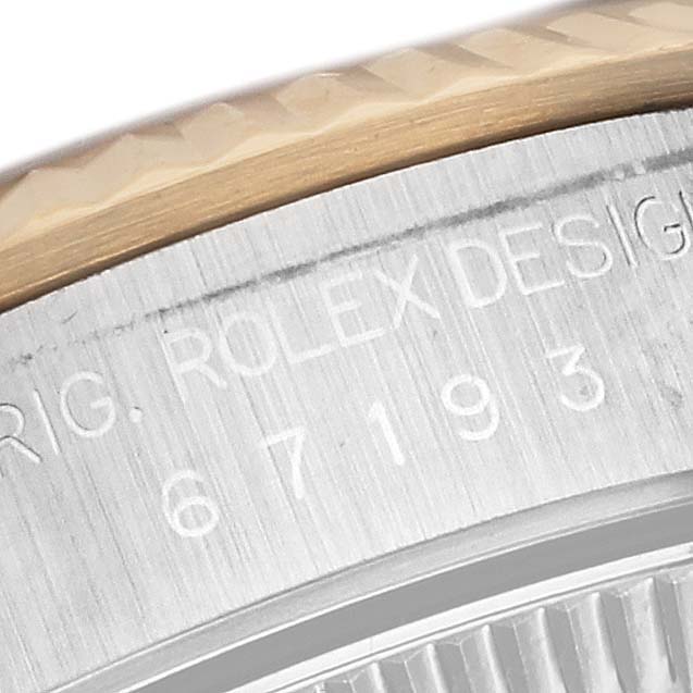 Close-up angled view of the engraved side of a Rolex Oyster Perpetual 67193 Women's Steel and Gold (two tone) Black Dial 67193 Women's Steel and Gold (two tone) Black Dial watch case.