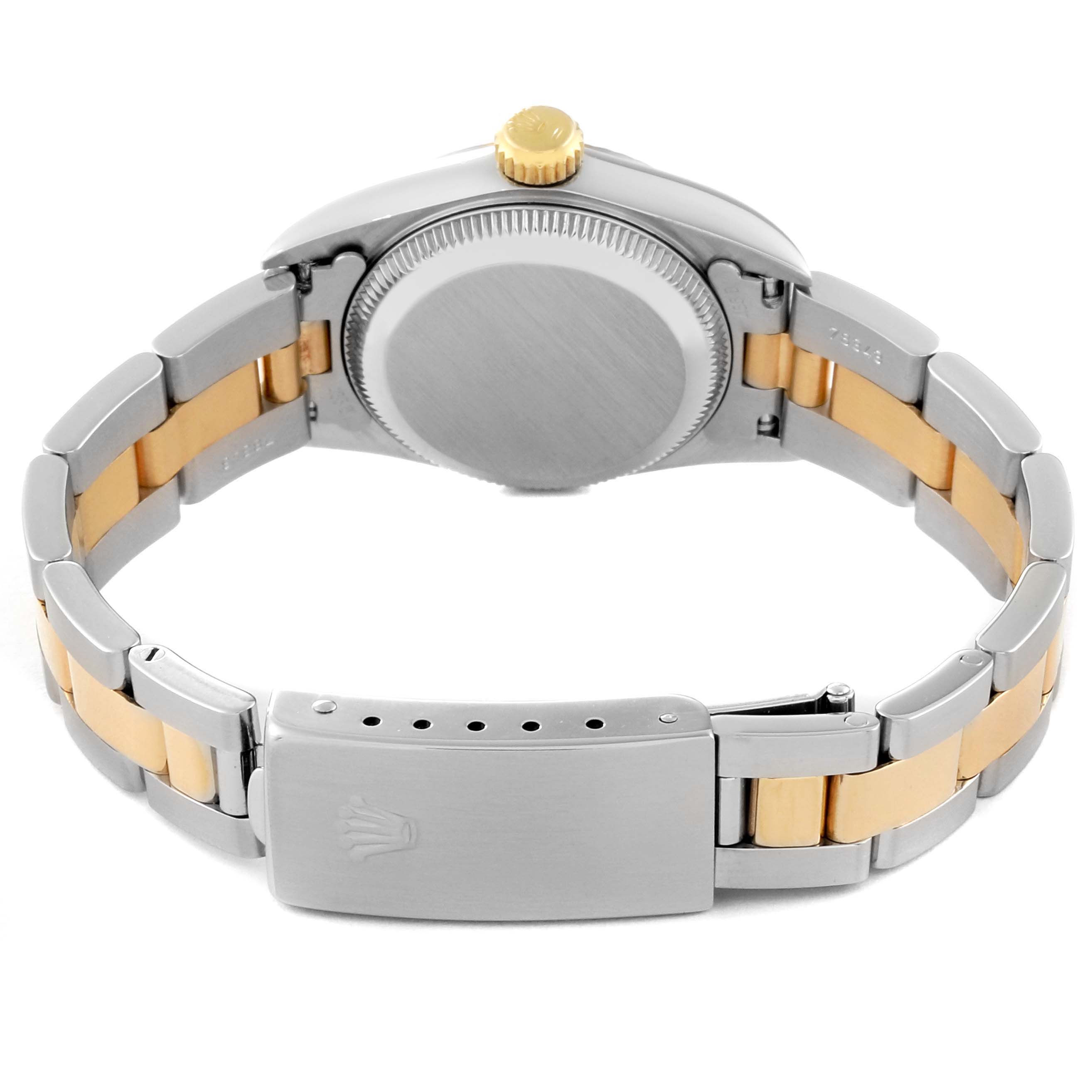 The image shows the back view of a Rolex Oyster Perpetual 67193 Women's Steel and Gold (two tone) Black Dial 67193 Women's Steel and Gold (two tone) Black Dial watch, highlighting its metal case, bracelet, crown, and clasp.