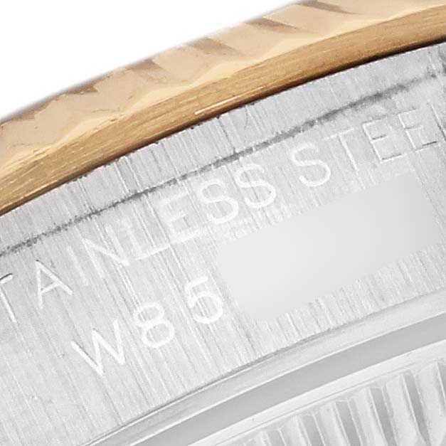 The image shows a close-up of the side of the casing and bezel of a Rolex Oyster Perpetual 67193 Women's Steel and Gold (two tone) Black Dial 67193 Women's Steel and Gold (two tone) Black Dial watch, highlighting the stainless steel text engraving.