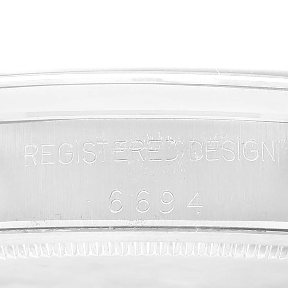 This image shows a close-up angle of the serial number engraving on a Rolex Vintage Collection 6694 Men's Stainless Steel Silver Dial 6694 Men's Stainless Steel Silver Dial model watch.