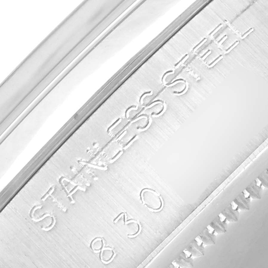 This close-up shows the stainless steel marking and part of the serial number on the case of a Rolex Vintage Collection 6694 Men's Stainless Steel Silver Dial 6694 Men's Stainless Steel Silver Dial watch.