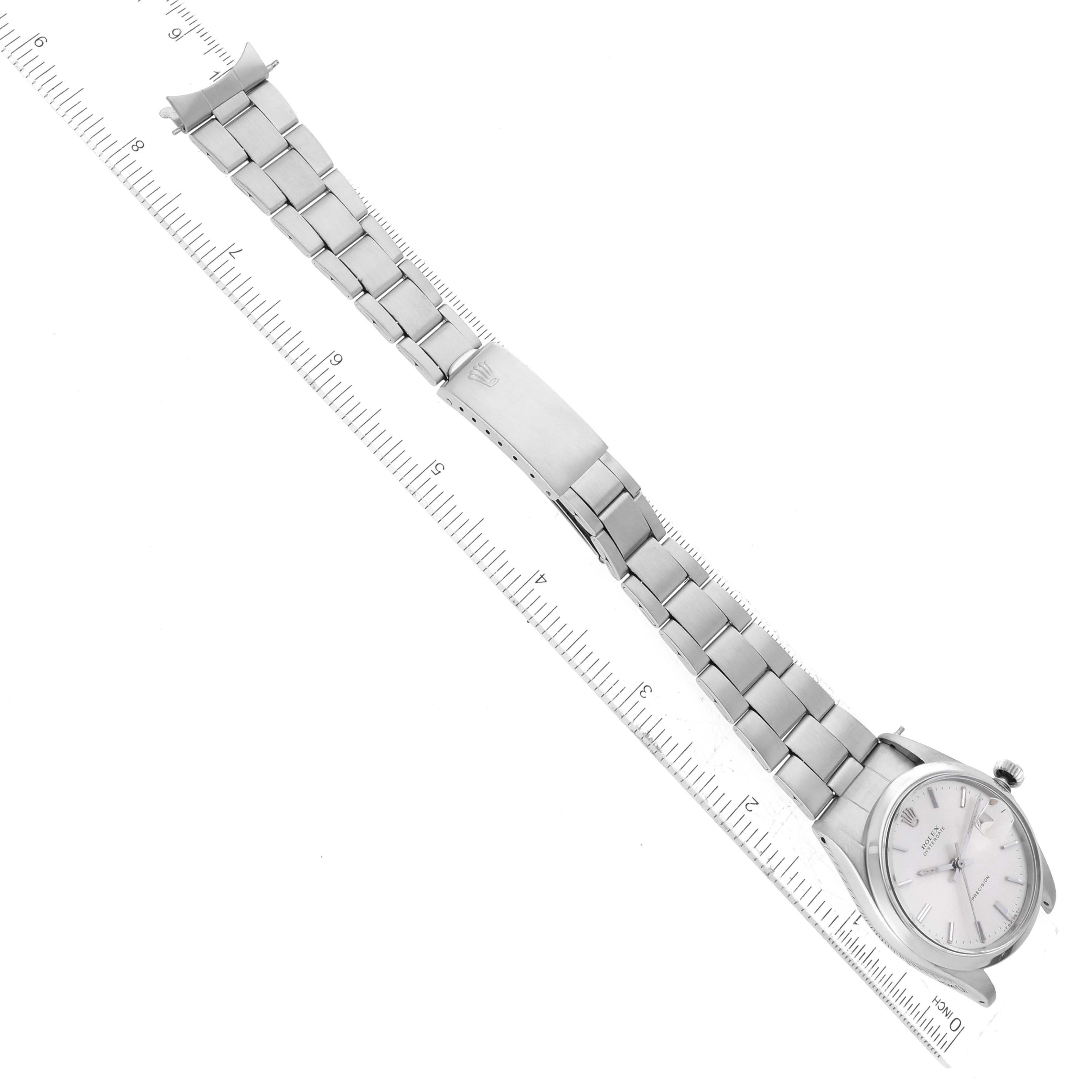 The image shows a Rolex Vintage Collection 6694 Men's Stainless Steel Silver Dial 6694 Men's Stainless Steel Silver Dial model watch laid flat alongside a ruler, displaying the watch face and metal bracelet.