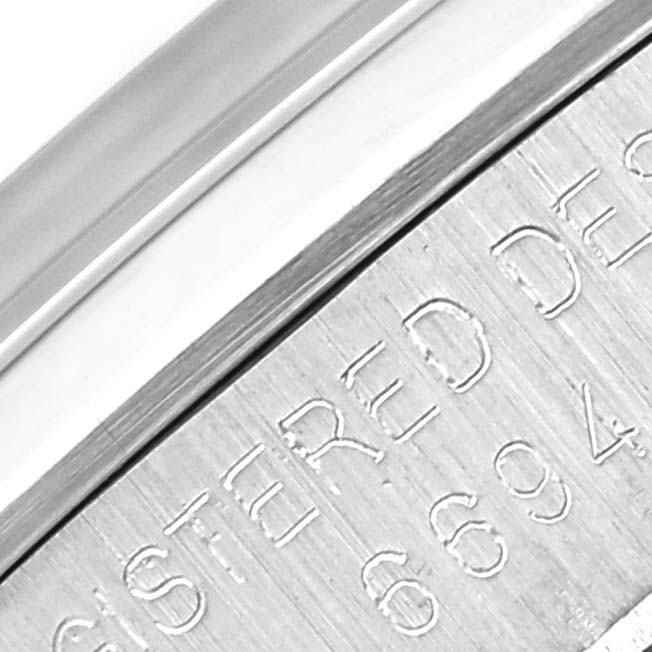This close-up image shows the engraved side of the bezel on a Rolex Vintage Collection 6694 Men's Stainless Steel Silver Dial 6694 Men's Stainless Steel Silver Dial model watch.