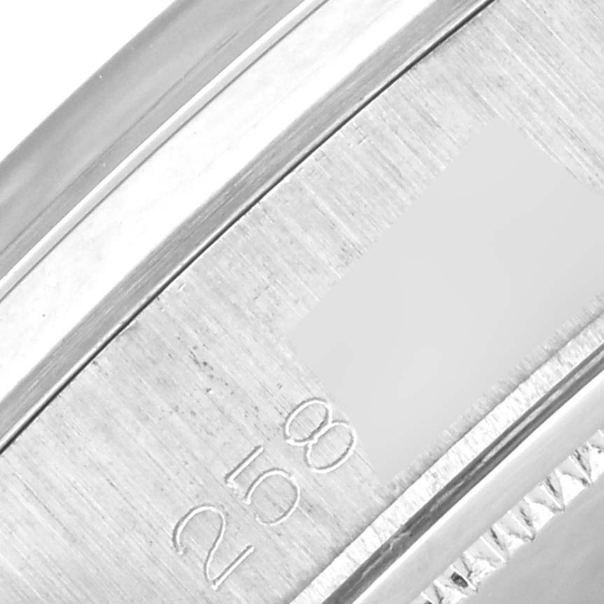 This close-up photo of the Rolex Vintage Collection 6694 Men's Stainless Steel Silver Dial 6694 Men's Stainless Steel Silver Dial model shows part of the case with etched engravings.