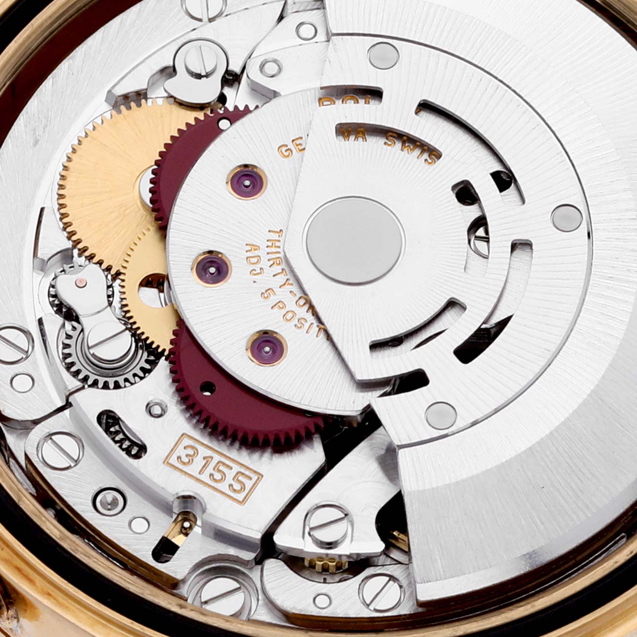 The image shows a close-up of the movement inside the President model by Rolex, including gears and the rotor.
