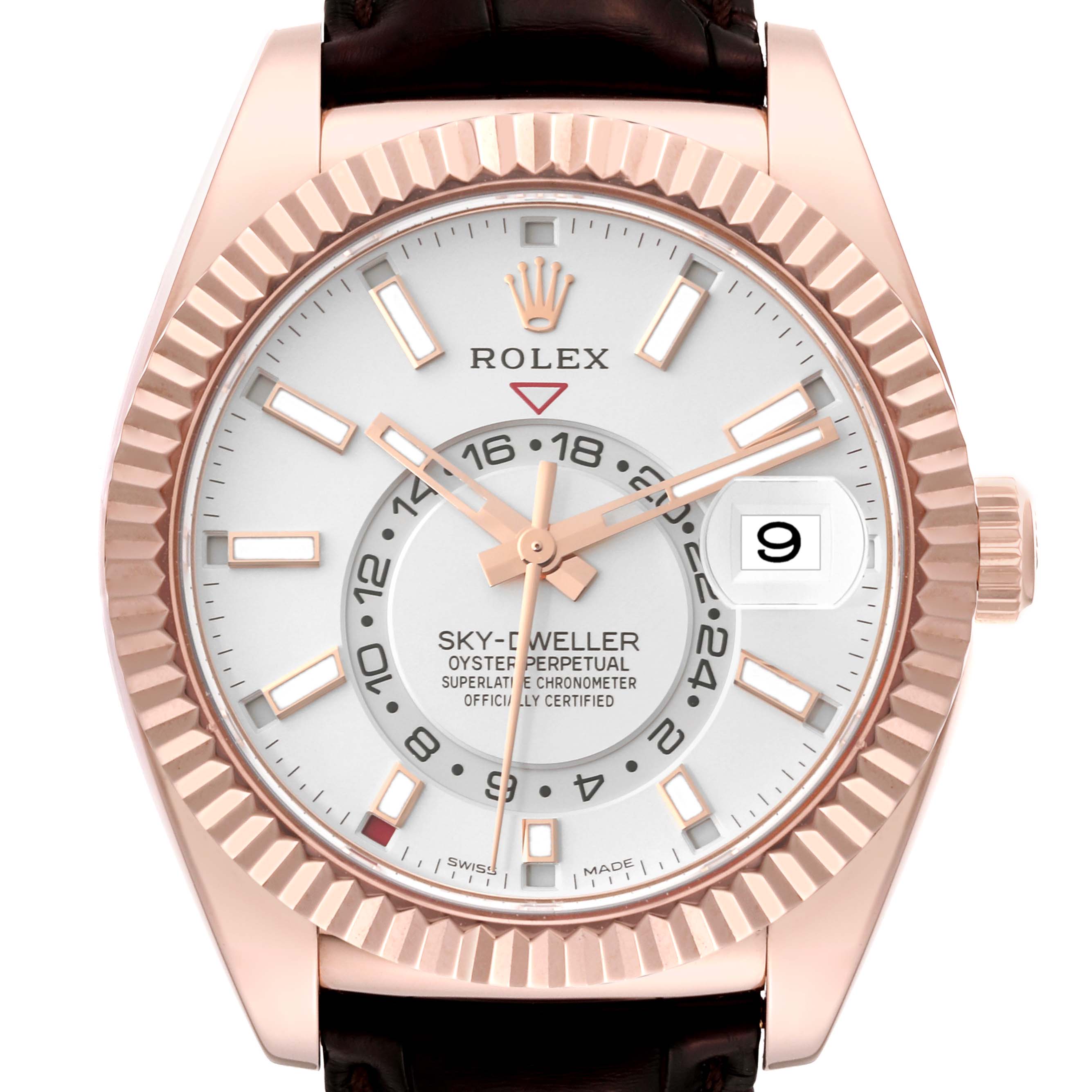 The Rolex Sky-Dweller model 326135 is shown from a front angle, featuring the dial, fluted bezel, hands, hour markers, and date window.