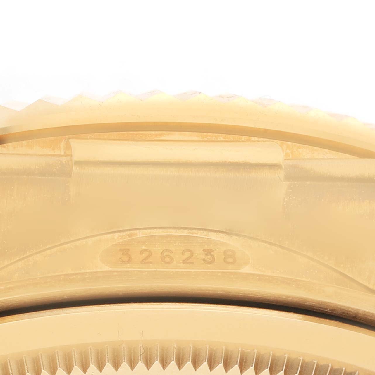 This is a close-up shot of the bezel and part of the case of a Rolex Sky-Dweller 326238 Men's Yellow Gold Black Dial 326238 Men's Yellow Gold Black Dial watch.