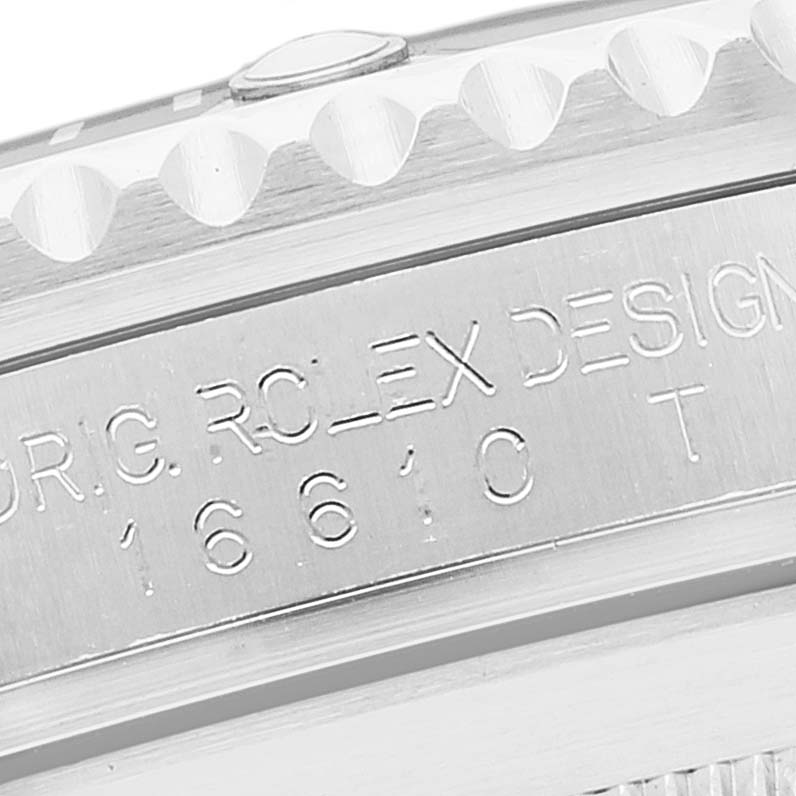 This image shows a close-up of the side engraving and part of the bezel of a Rolex Submariner 16610 Men
s Stainless Steel Black Dial 16610 Men
s Stainless Steel Black Dial.