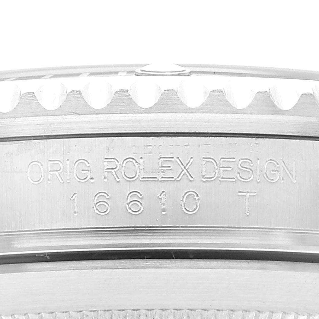 The image shows a close-up of the side of a Rolex Submariner 16610 Men
s Stainless Steel Black Dial 16610 Men
s Stainless Steel Black Dial, highlighting its bezel and the etched model number "16610 T".