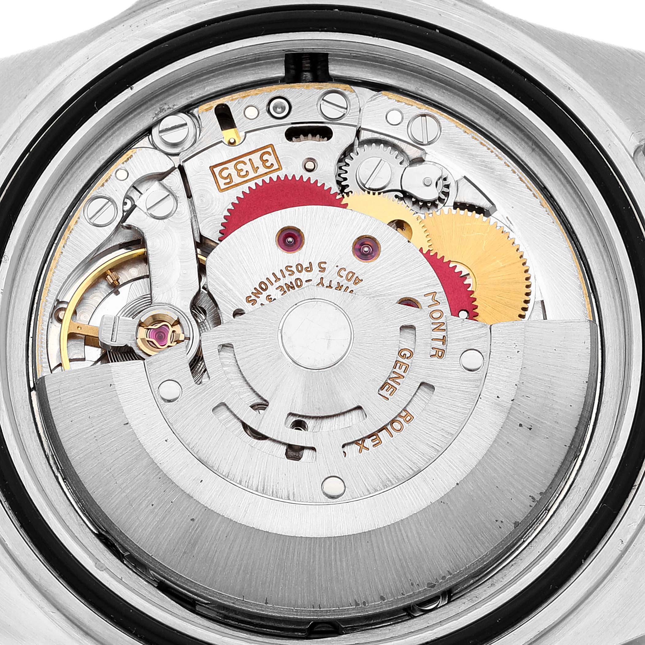 The image shows a close-up of the movement inside the Rolex Submariner 16610 Men
s Stainless Steel Black Dial 16610 Men
s Stainless Steel Black Dial watch, highlighting its intricate gears and components.