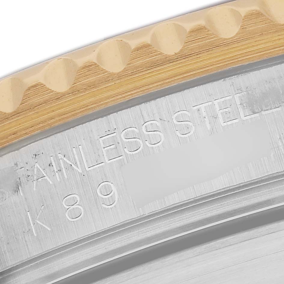 This image shows the engraved stainless steel back and the gold ridged bezel edge of a Rolex Submariner 16613 Men's Steel and Gold (two tone) Blue Dial 16613 Men's Steel and Gold (two tone) Blue Dial watch.