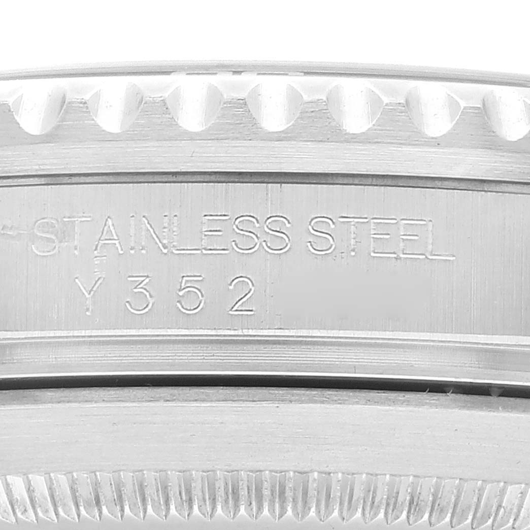 The image shows a close-up of the side of a Rolex Submariner 16610 Men
s Stainless Steel Black Dial 16610 Men
s Stainless Steel Black Dial, highlighting the stainless steel material and the inscribed serial number "Y352".
