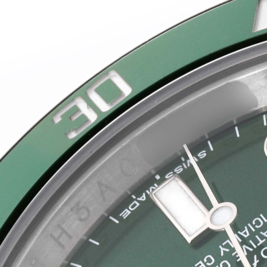 This close-up angle of the Rolex Submariner 116610LV Men's Stainless Steel Green Dial 116610LV Men's Stainless Steel Green Dial watch shows the green bezel and part of the dial with the minute hand.