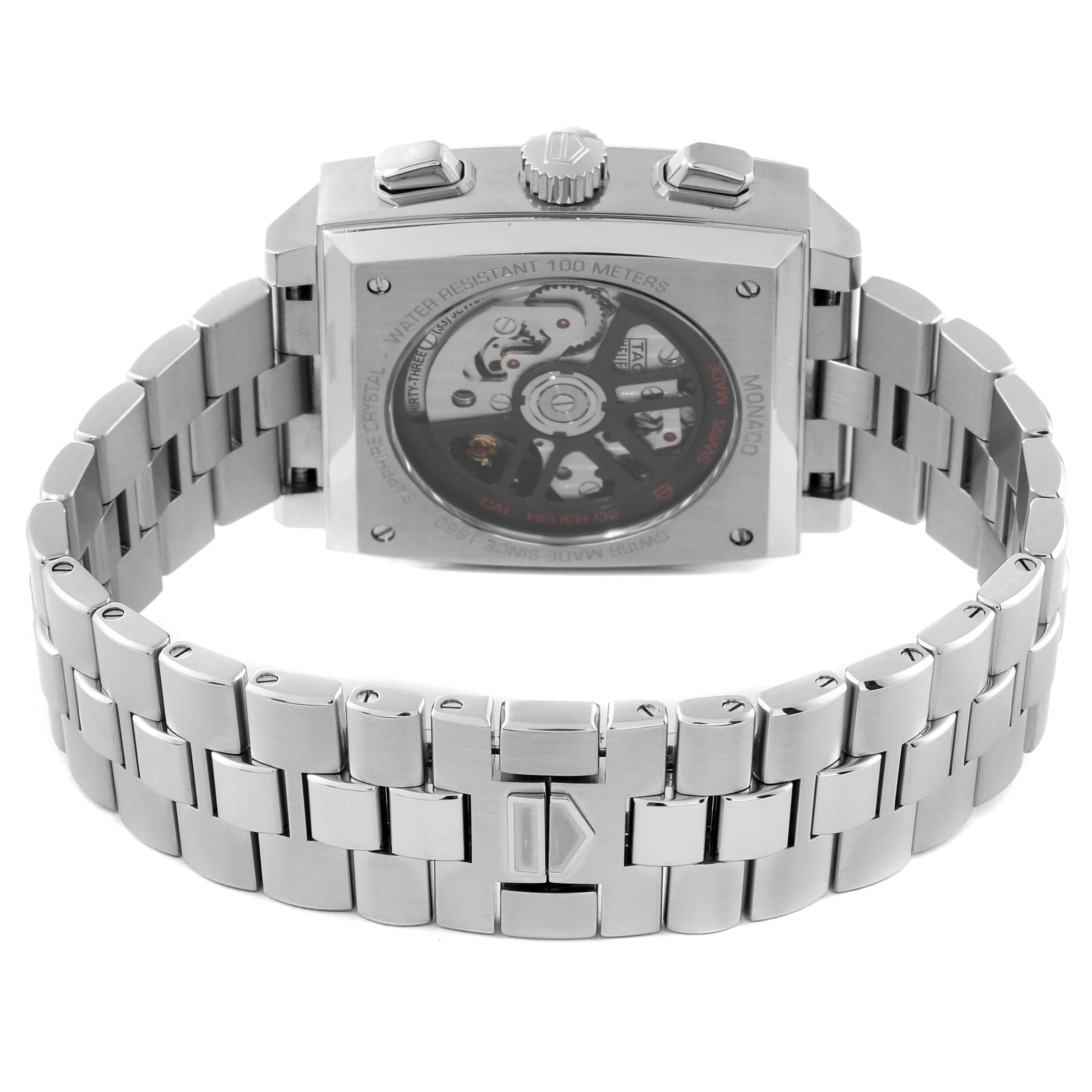 The image shows the back view of a Tag Heuer Monaco CBL2111.BA0644 Men's Stainless Steel Blue Dial CBL2111.BA0644 Men's Stainless Steel Blue Dial watch, highlighting its stainless steel bracelet and visible movement through the sapphire case back.