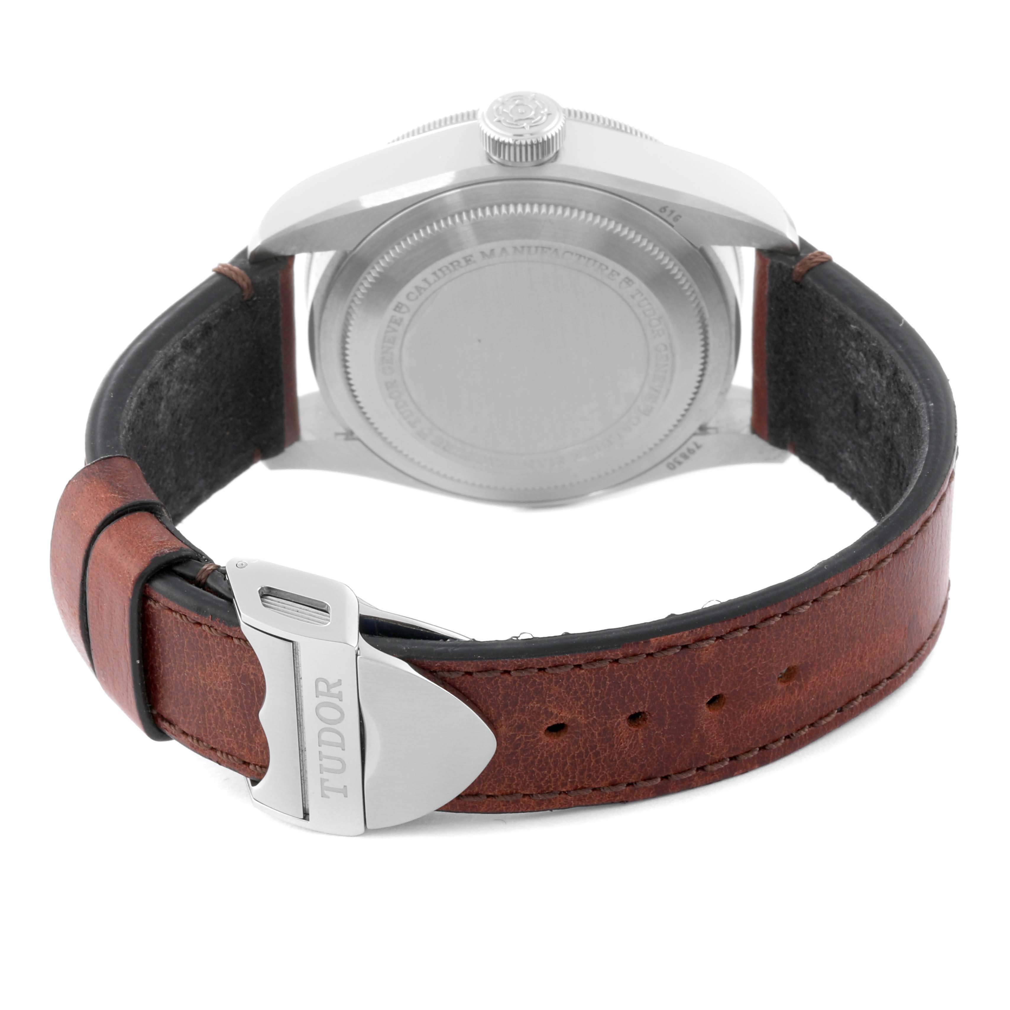 The image shows the back view of a Tudor Heritage Black Bay 79830RB Men
s Stainless Steel Black Dial 79830RB Men
s Stainless Steel Black Dial watch, highlighting the case back and brown leather strap with a Tudor clasp.