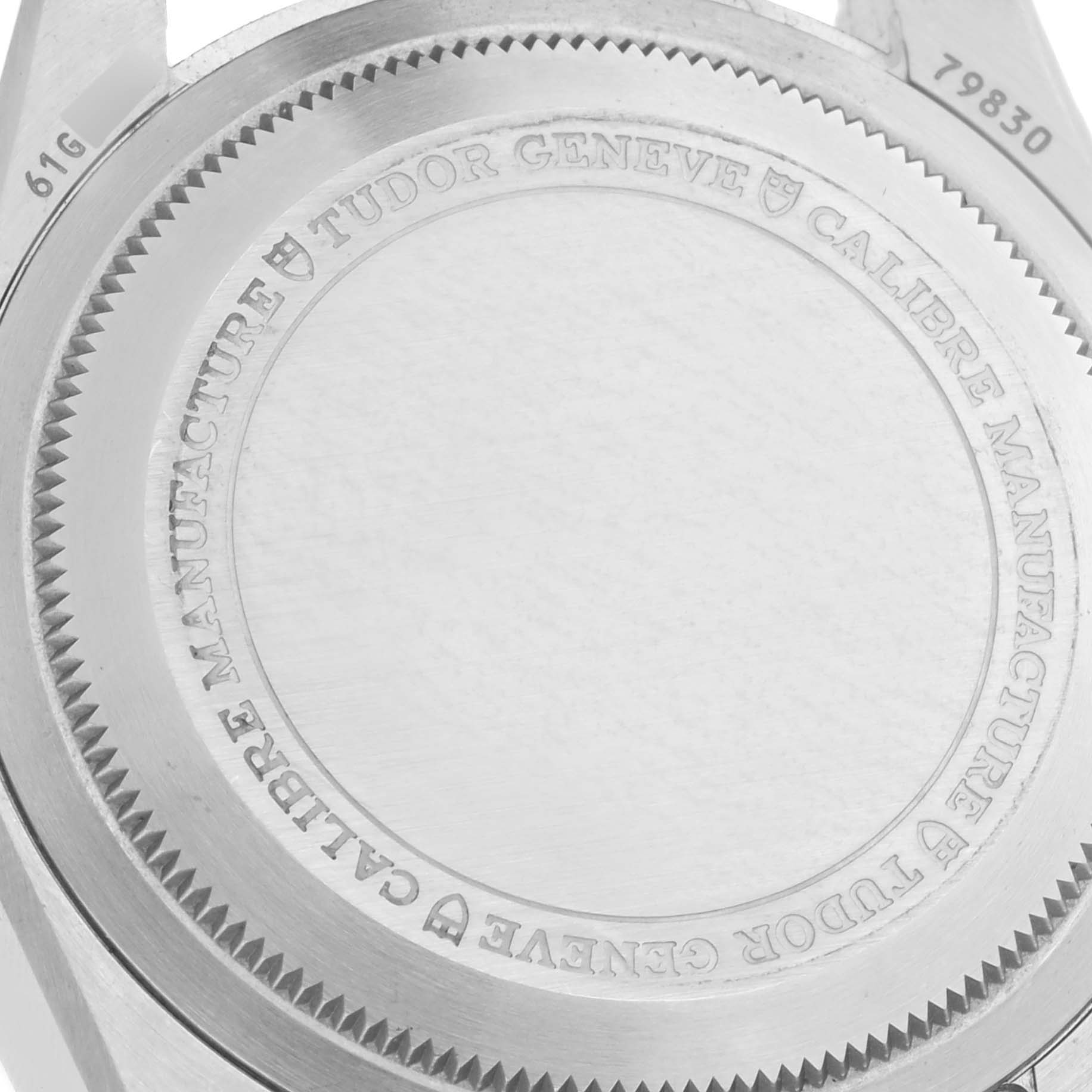 The image shows the back case of a Tudor Heritage Black Bay 79830RB Men
s Stainless Steel Black Dial 79830RB Men
s Stainless Steel Black Dial watch, highlighting inscriptions and case details.