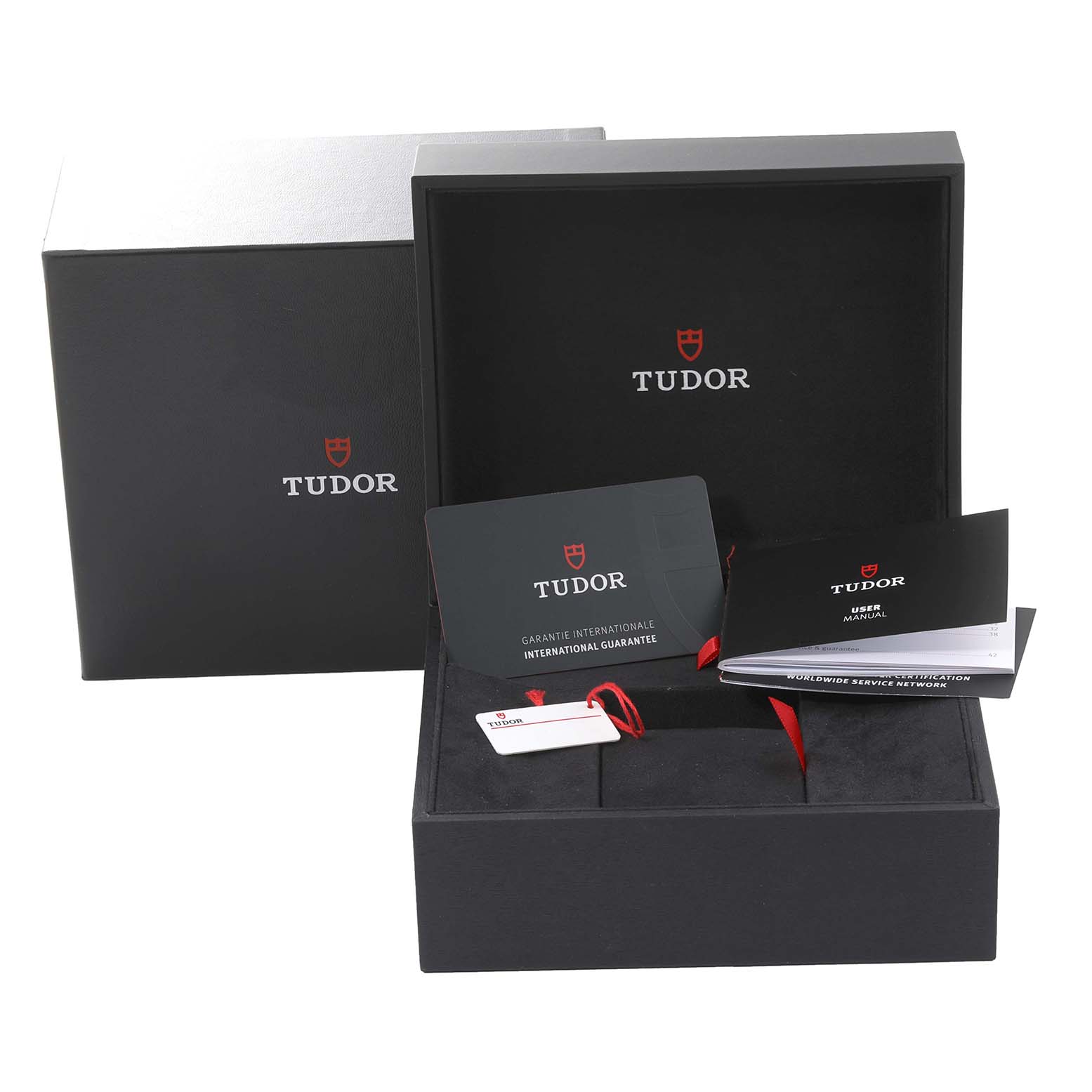 The image shows the packaging and accessories, including warranty cards and manuals, for a Tudor Heritage Black Bay 79830RB Men
s Stainless Steel Black Dial 79830RB Men
s Stainless Steel Black Dial watch.
