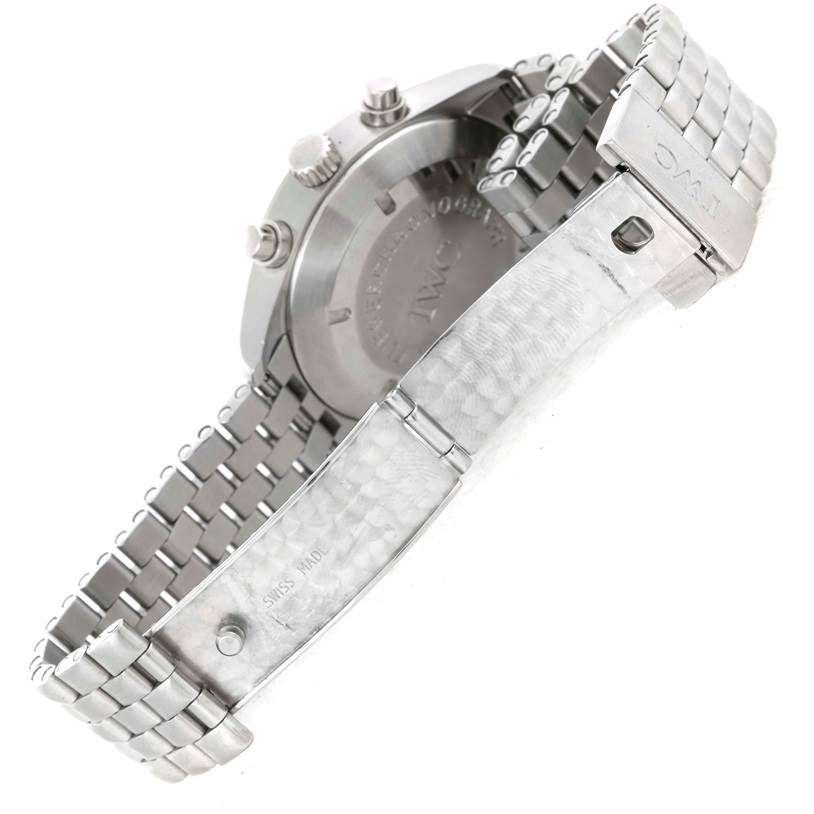 The image shows the underside and clasp of the Pilot watch by IWC, highlighting the stainless steel bracelet and back case.