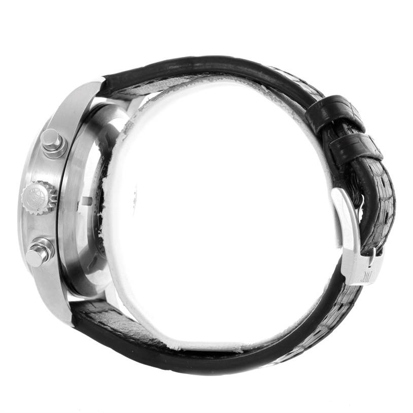 The image shows a side view of the IWC Pilot IW377701 Men's Stainless Steel Black Dial IW377701 Men's Stainless Steel Black Dial watch, highlighting its crown, pushers, and leather strap with buckle.