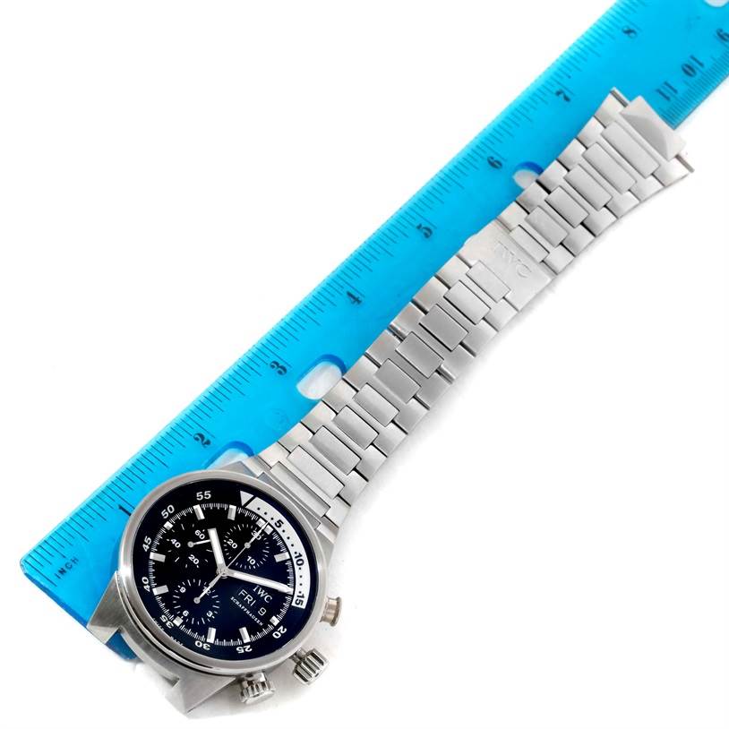 The image shows an IWC Aquatimer IW371928 Men's Stainless Steel Black Dial IW371928 Men's Stainless Steel Black Dial watch at an angle, displaying its face and metal bracelet, next to a blue ruler for scale.