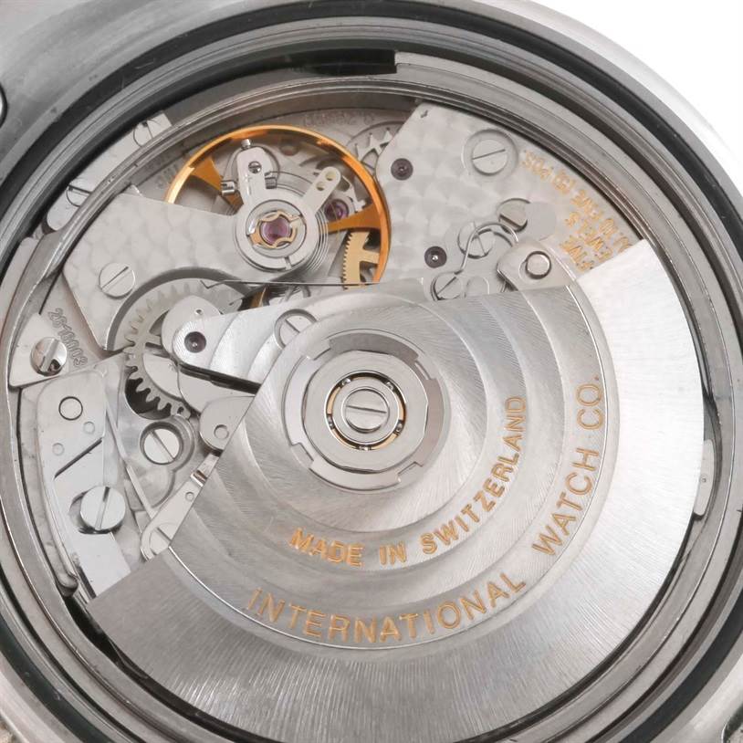 The image shows the internal mechanism of an IWC Aquatimer IW371928 Men's Stainless Steel Black Dial IW371928 Men's Stainless Steel Black Dial watch with visible gears and the rotor engraved with "International Watch Co."