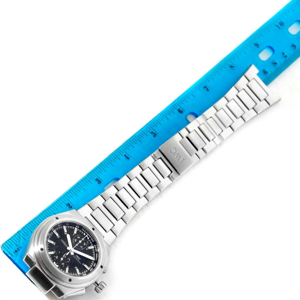 The IWC Ingenieur IW372501 Men's Stainless Steel Black Dial IW372501 Men's Stainless Steel Black Dial watch is shown from an overhead angle, displaying the face, bracelet, and clasp beside a ruler for scale.