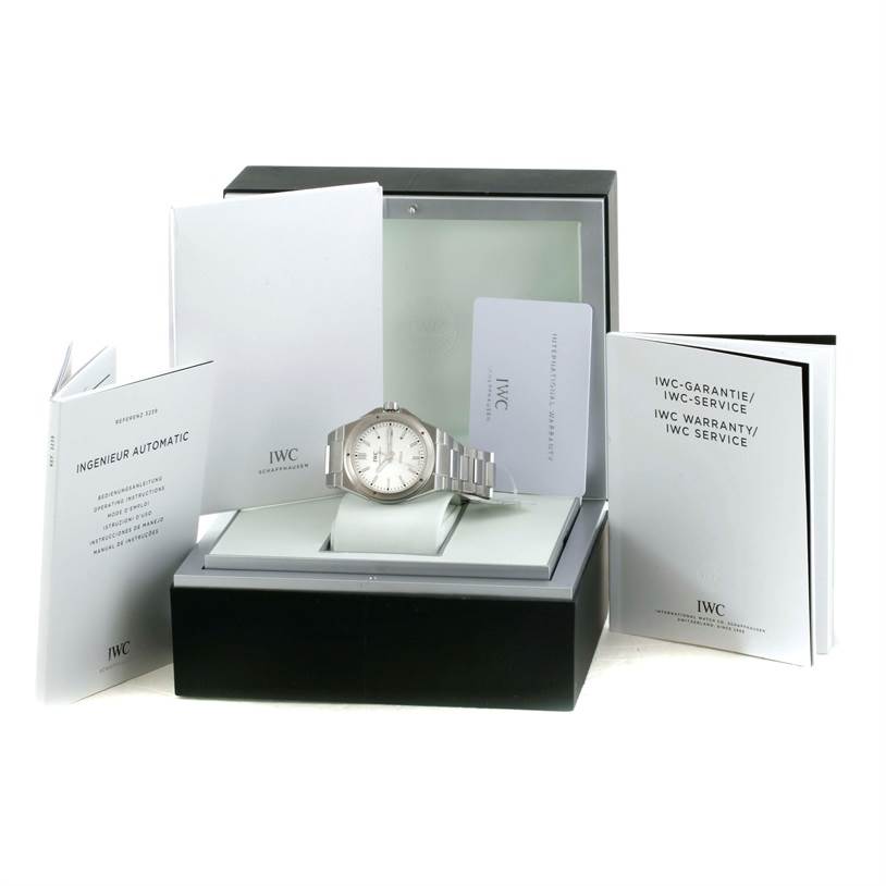 The IWC Ingenieur IW323904 Men's Stainless Steel Silver Dial IW323904 Men's Stainless Steel Silver Dial watch is shown front-facing in its box, surrounded by manuals and warranty cards.